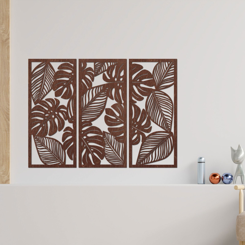 Modern wall decoration: three panels with cutouts of monstera leaves.