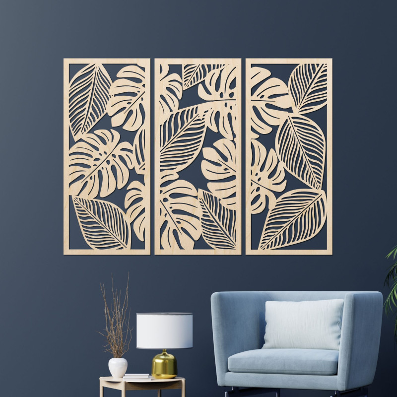 Modern wall decoration: three panels with cutouts of monstera leaves.