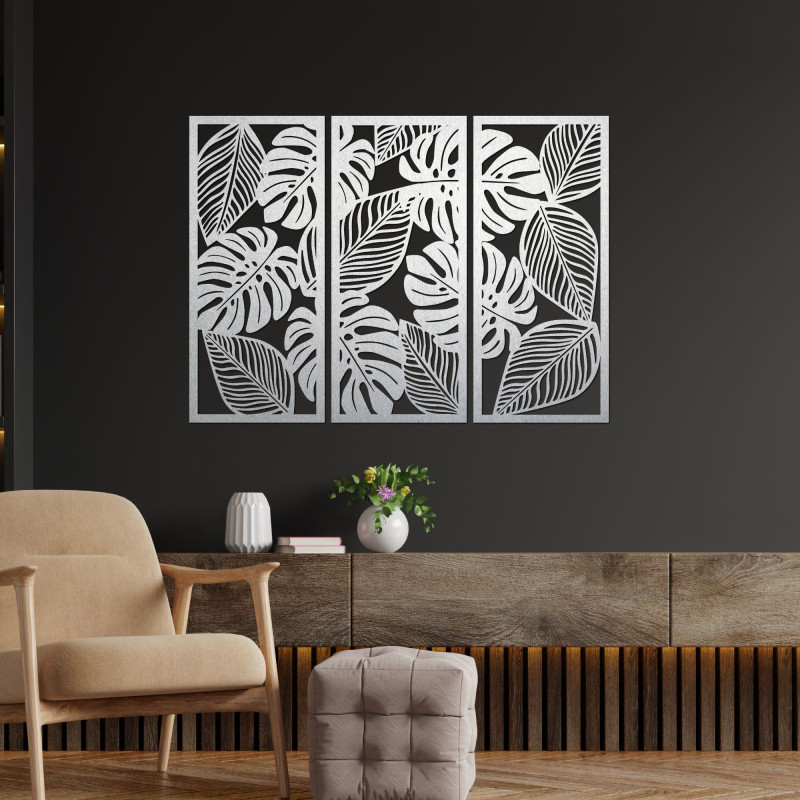 Modern wall decoration: three panels with cutouts of monstera leaves.