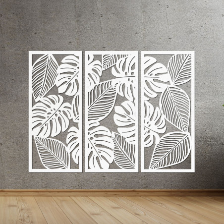 Modern wall decoration: three panels with cutouts of monstera leaves.