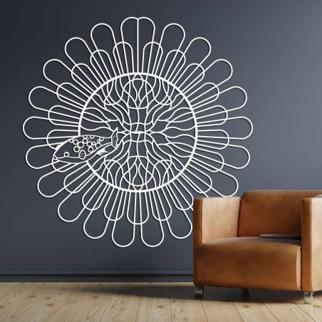 Black wooden mandala with fish on a white wall in a modern apartment