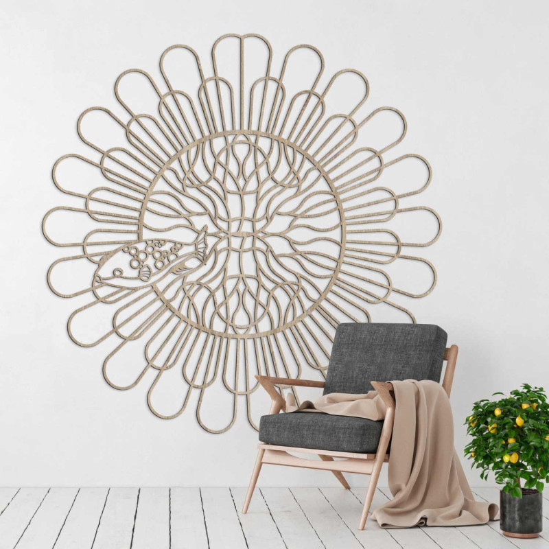 Black wooden mandala with fish on a white wall in a modern apartment