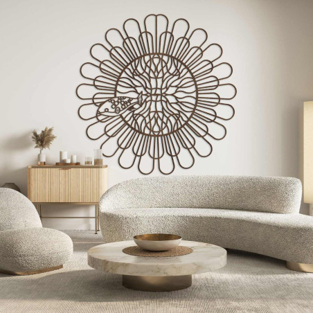 Black wooden mandala with fish on a white wall in a modern apartment