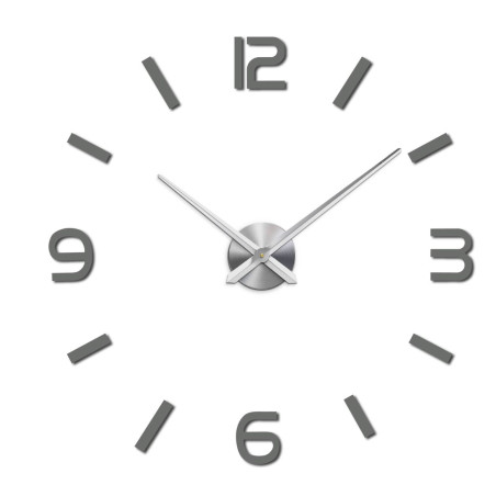Wall clock with mirror elements in silver color on the wall in the interior