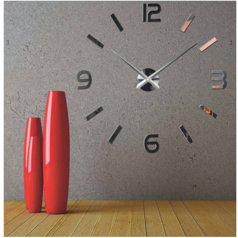 Wall clock with mirror elements in silver color on the wall in the interior