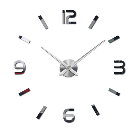 Wall clock with mirror elements in silver color on the wall in the interior
