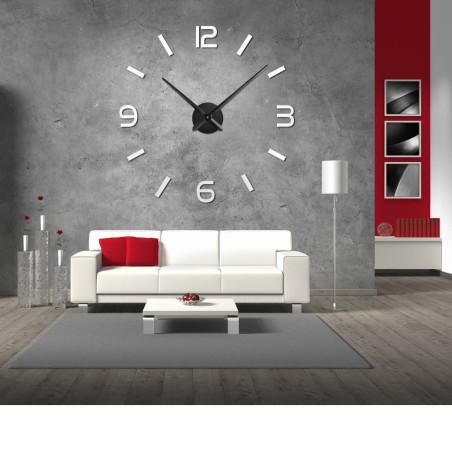 Wall clock with mirror elements in silver color on the wall in the interior