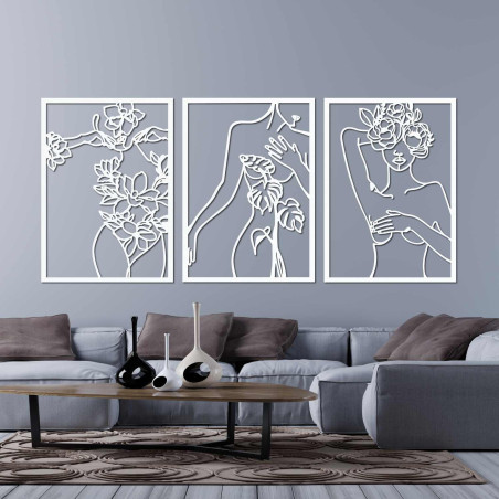 Elegant three-part painting of a woman with floral elements on the wall
