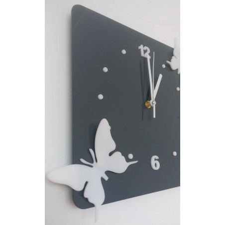 Modern wall clock made of plexiglass. Trendy clock on the wall as a gift. X-momo clocks. PMMA Modern wall clock made of plexiglass. Trendy clock on the wall as a gift. X-momo clocks. PMMA