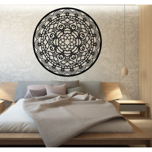 The mandala of life is rounded by a wooden picture on a wall made of SUSEN